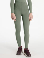 Front view of a model wearing the green Lemieux Young Rider Orla Pull On Tight on a white background