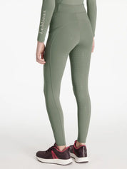Back view of a model wearing the green Lemieux Young Rider Orla Pull On Tight on a white background