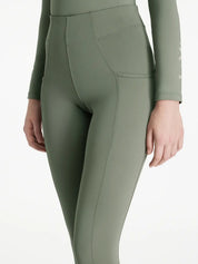 Close-up angled front view of a model wearing the green Lemieux Young Rider Orla Pull On Tight on a white background