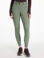 Front view of a model wearing the green LeMieux Isabelle Knee Grip Breeches on a white background