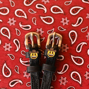Close-up view of the Cowboy Emoji Mane Jane Spur Straps on a red paisley bandana background