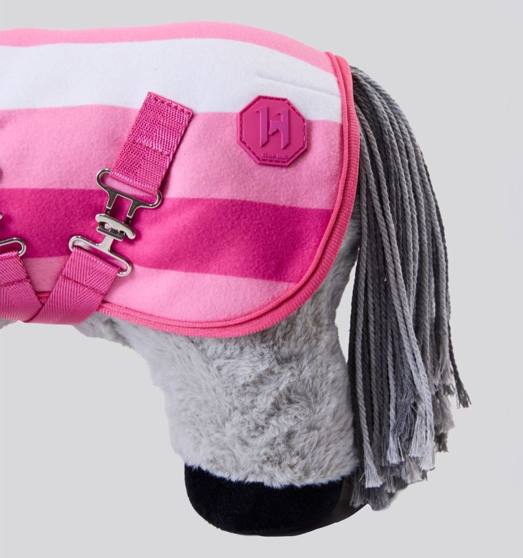 Side view of the hind end of a gray stuffed pony wearing the pink Newmarket Fleece Cooler