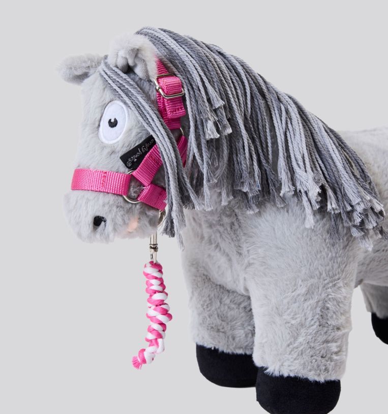 Side angled view of a stuffed gray pony wearing a pink halter and lead rope