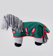 Side view of a gray stuffed animal pony wearing Rambo turnout blanket that is green with red accents