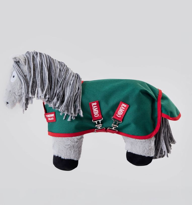 Side view of a gray stuffed animal pony wearing Rambo turnout blanket that is green with red accents