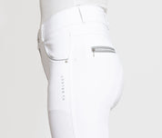 Close-up side view of a model wearing the white KL Select Gabrielle Full Seat Breech on a white background