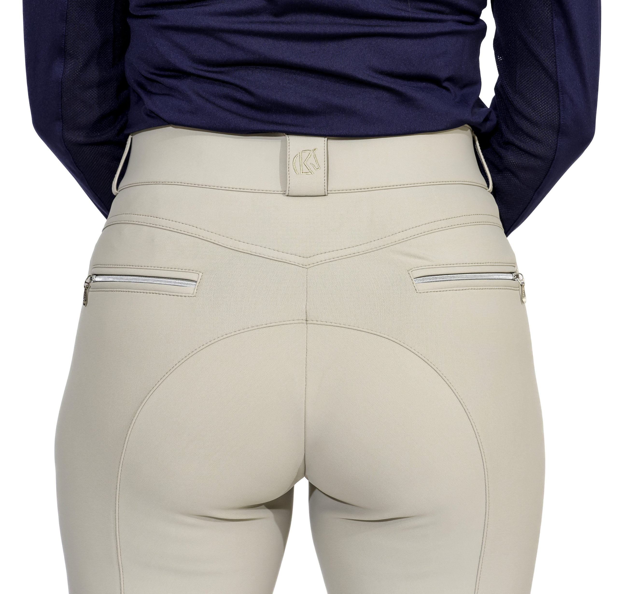 Close-up back view of a model wearing the beige KL Select Gabrielle Knee Patch Breech on a white background
