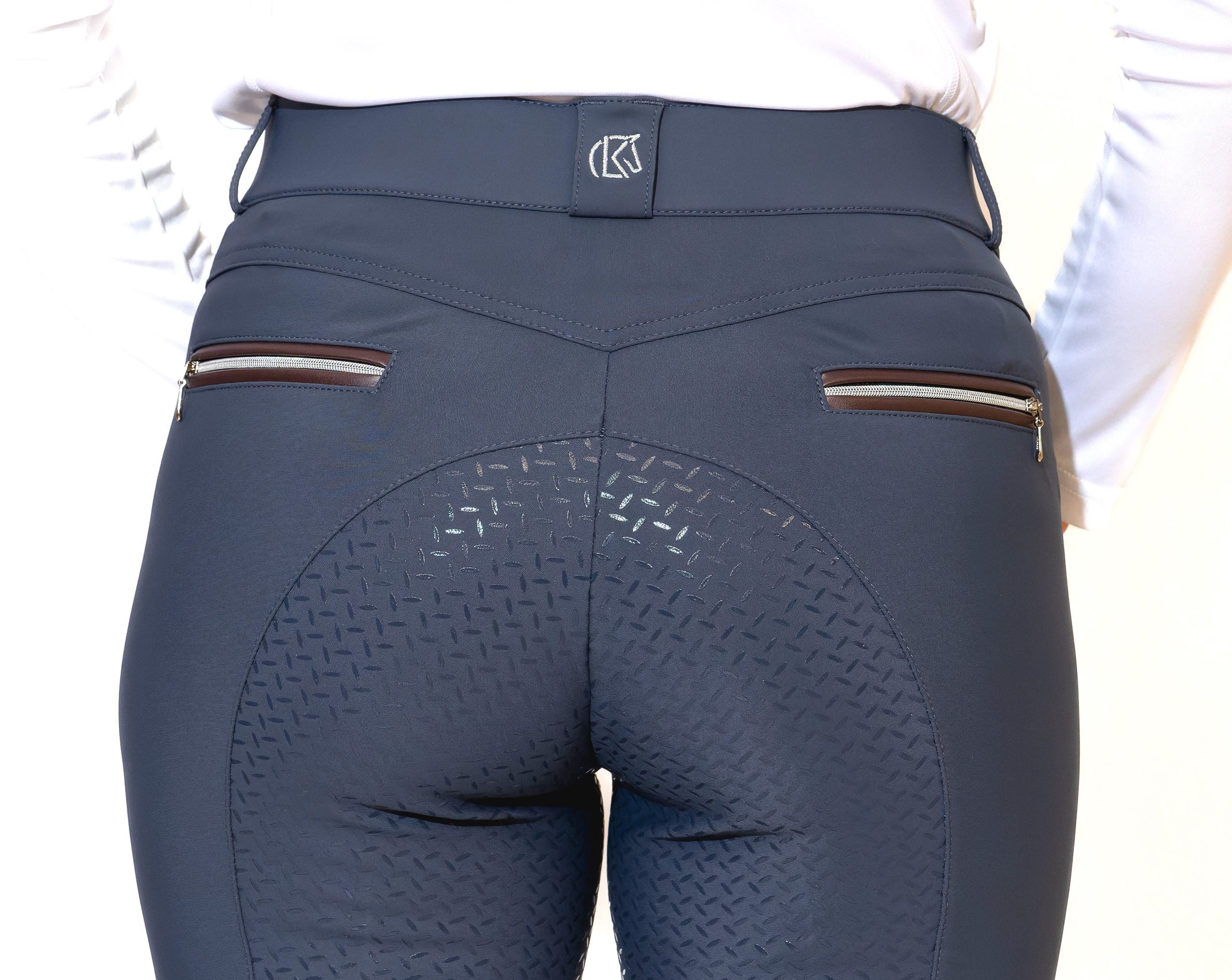 Close-up back view of a model wearing the slate blue KL Select Gabrielle Full Seat Breech on a white background
