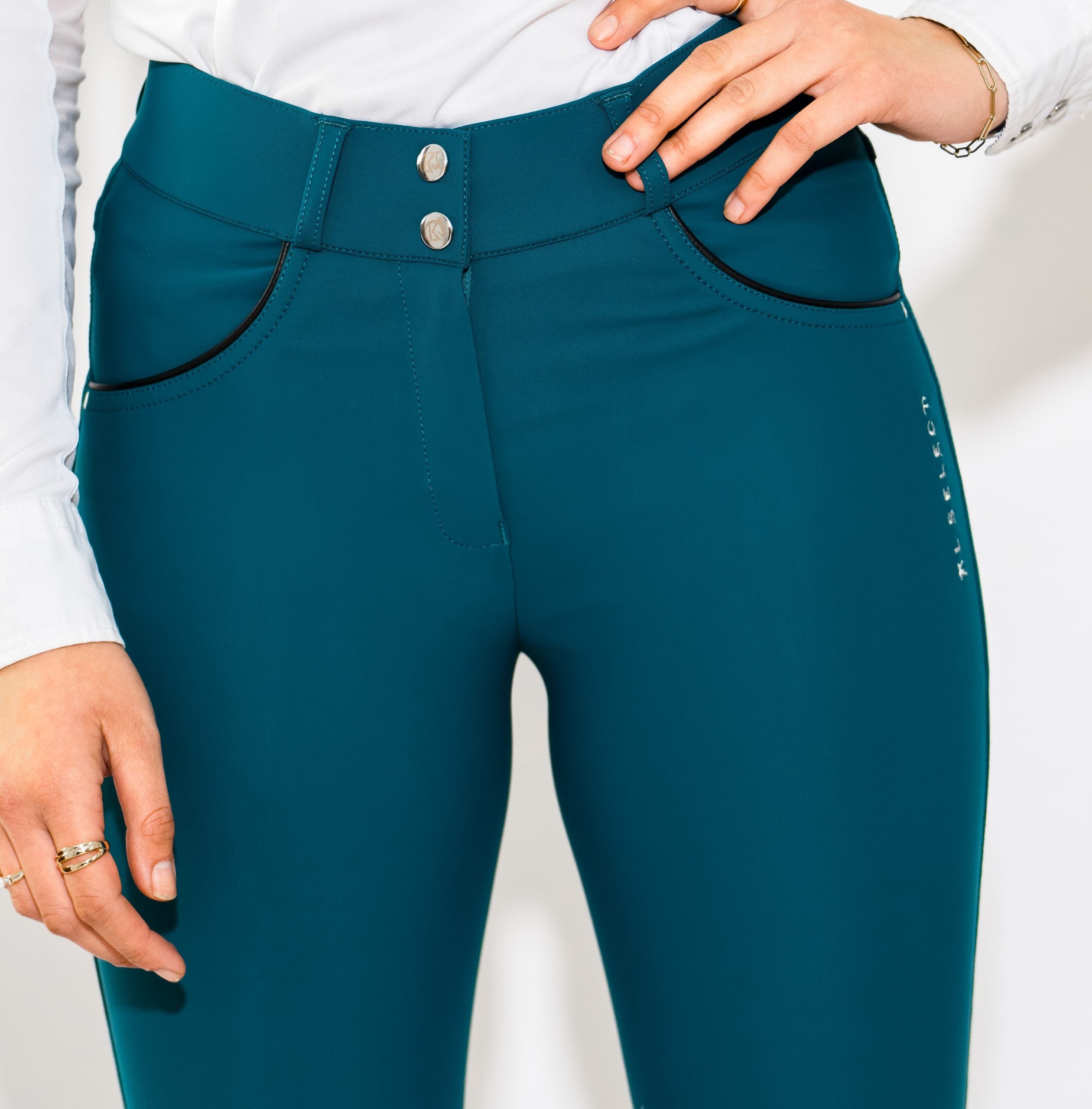 Close-up front view of a model wearing the teal KL Select Gabrielle Breech on a white background