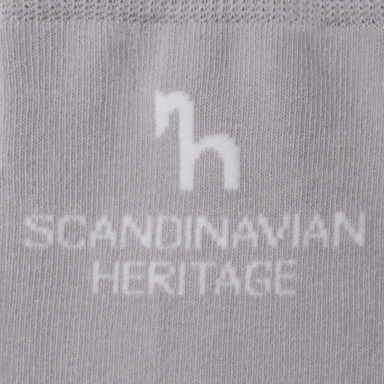 Close-up view of the Scandinavian Heritage horse logo on the gray Horze Noya Knee Socks