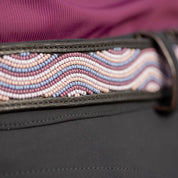View of a black leather Equinavia Estelle Hand Beaded Belt with pink, purple, and tan beading on a black pair of breeches