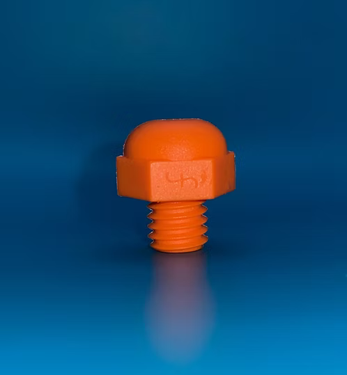 An orange plastic threaded cap with a rounded top, shown standing upright on a reflective blue gradient background.