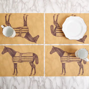View of the ThomasPaul Equestrian Vintage Woven Vinyl Placemat Set of 4 on a marble surface and a few dinnerware pieces on the placemats