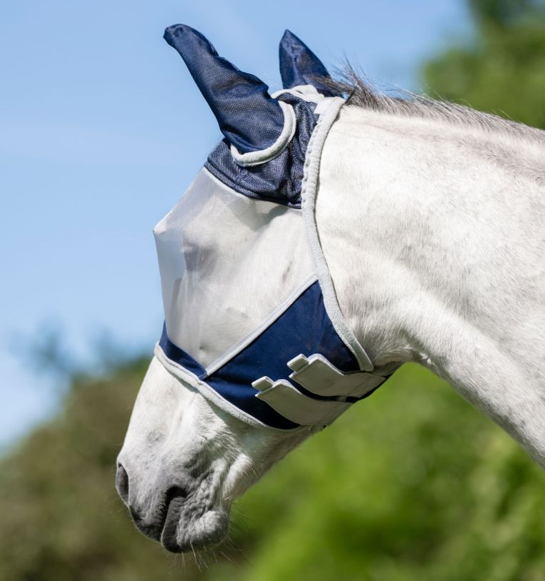 Horse wearing Horseware Shield Fly Mask in navy and silver, side view of head