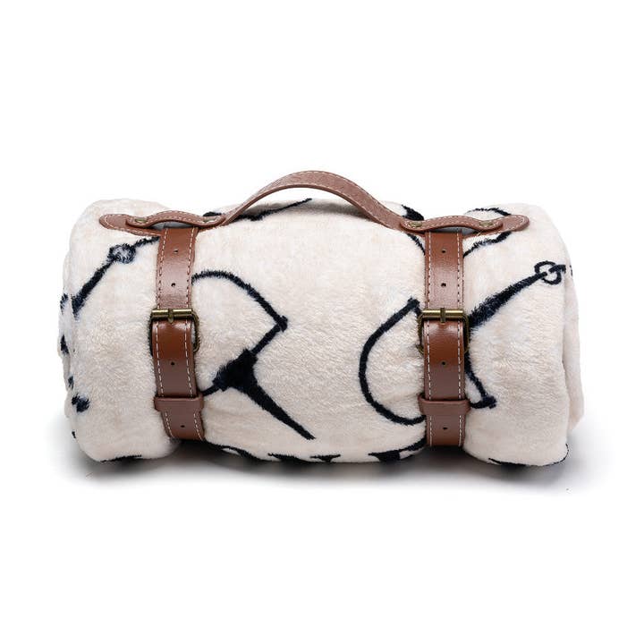 View of the rolled up snaffle Blue Stallion Farm Flannel Fleece Blanket in Leather Holder on a white background