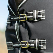 Front view of the chest closures on the black Equinavia Fryd Cotton Stable Sheet