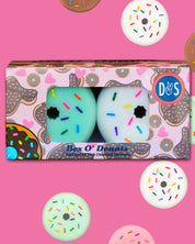View of a box of the Dreamers and Schemers Box O' Donuts Tack Cleaning Sponges on a pink background with donut sponges