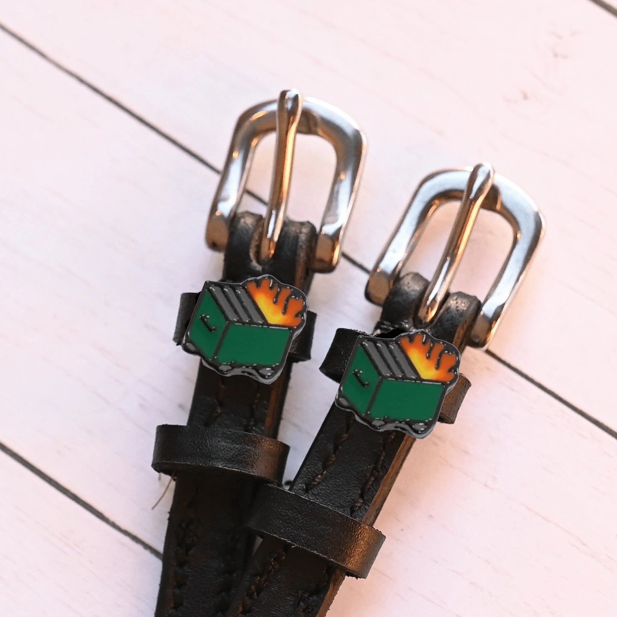 Close-up view of the Dumpster Fire Mane Jane Spur Straps charms and buckles