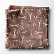 Front view of a folded mauve bit Canary Road Kitchen Towel on a white background