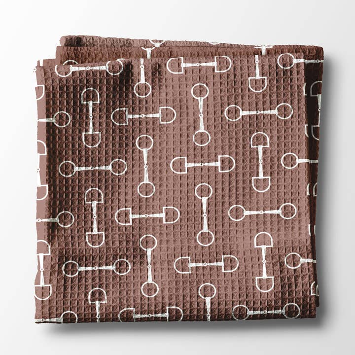 Front view of a folded mauve bit Canary Road Kitchen Towel on a white background