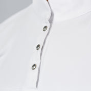 Close-up front view of a female model wearing the white Horze Mina Short Sleeve Crystal Show Shirt