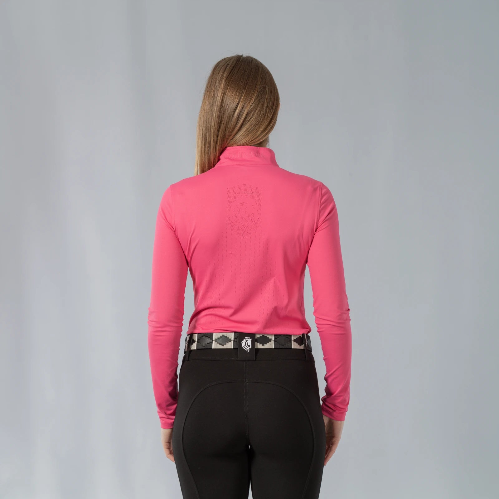 Back view of a model wearing the Equinavia Kari Womens Long Sleeve Sun Shirt with NordicAir Tech in pink on a gray background