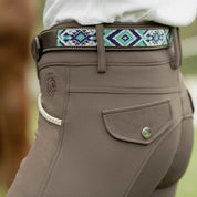 Close-up side view of a model wearing the dark brown leather Equinavia Estelle Hand Beaded Belt with blue, turquoise, and white beading