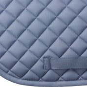 Side closeup view of Dusk Blue Equinavia Harstad Ribbon Dressage Pad on a white background