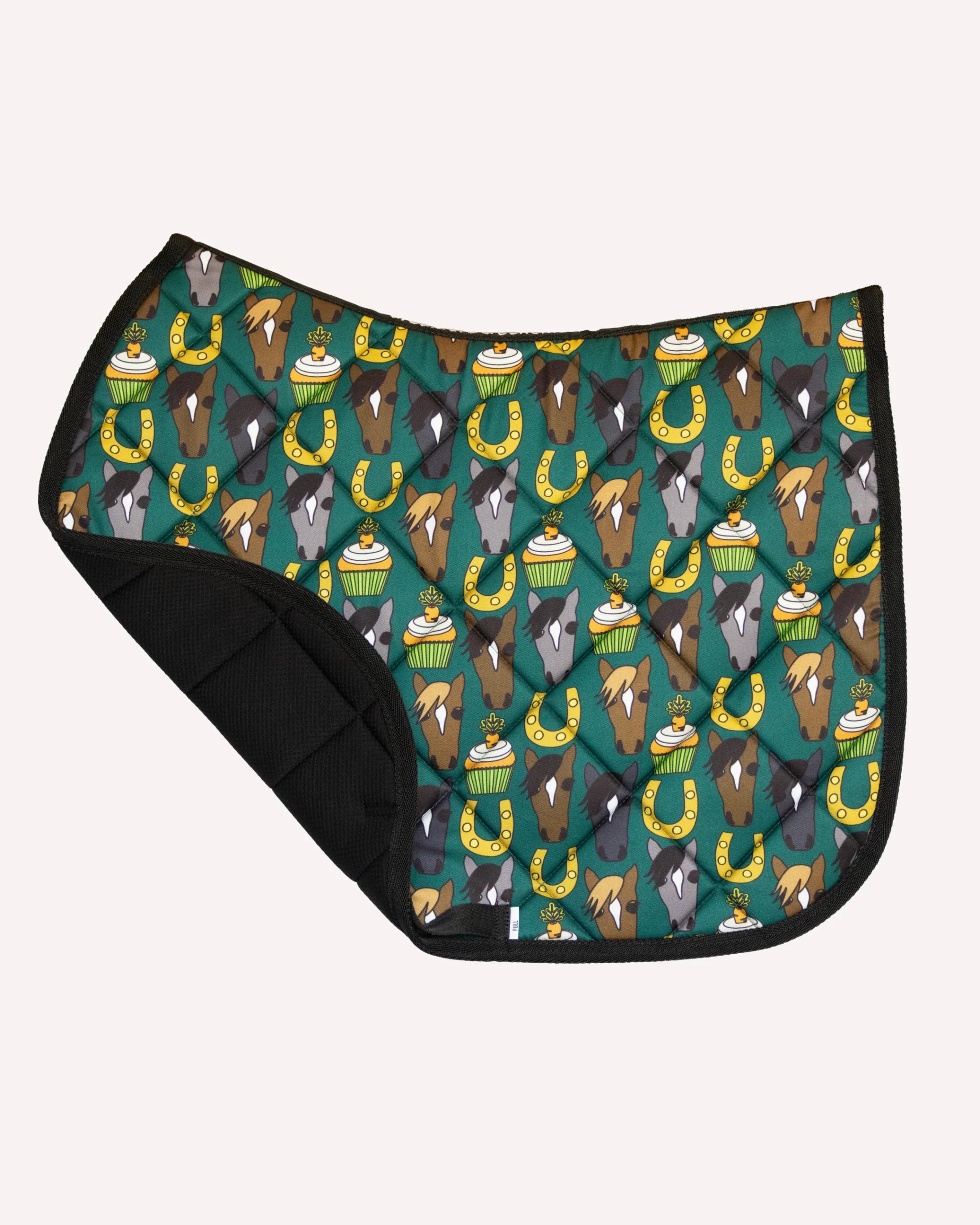 Side view of the Carrot Cake Dreamers & Schemers Saddle Pad on a plain background with the corner turned up to show the mesh lining
