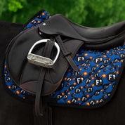 Side view of a black horse wearing the F Bomb Dreamers & Schemers Saddle Pad under a jump saddle