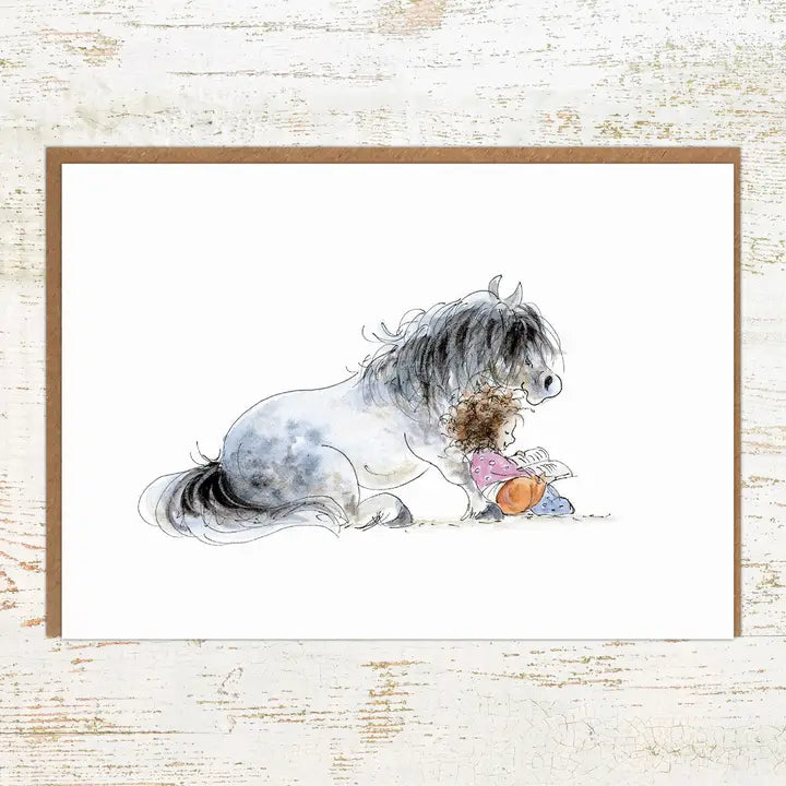 View of the Storytime Pony Nut Greeting Card on a white washed wood background