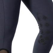Close-up side view of a model wearing the navy Equinavia Maud Knee Patch Breeches on a white background
