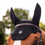 Close-up front view of a chestnut horse wearing the black swarovski Samshield Flyshield Fly Veil