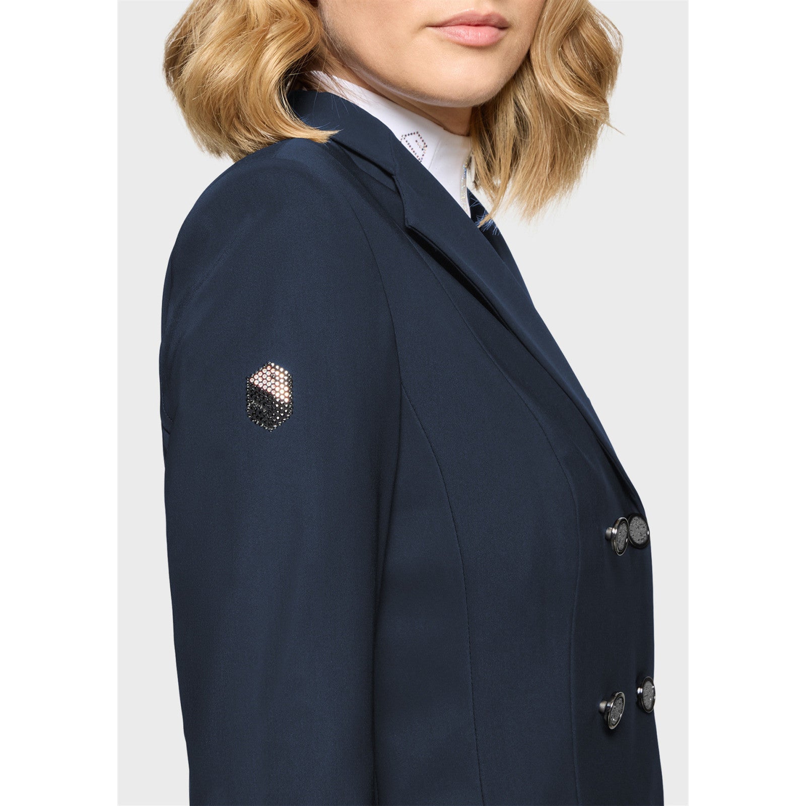Close-up side view of a female model wearing the Navy Samshield Frac Crystal Fabric Show Coat on a plain background