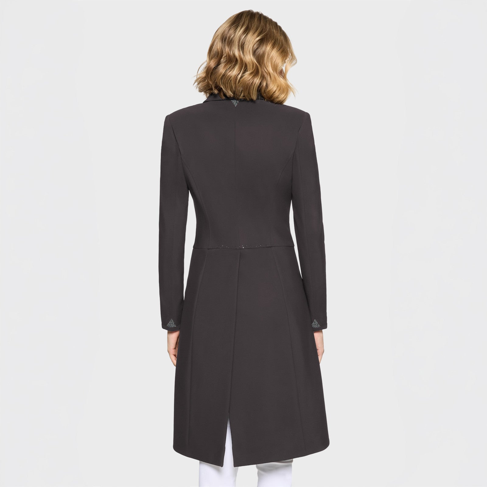 Back view of a female model wearing the Truffle Samshield Frac Crystal Fabric Show Coat on a plain background