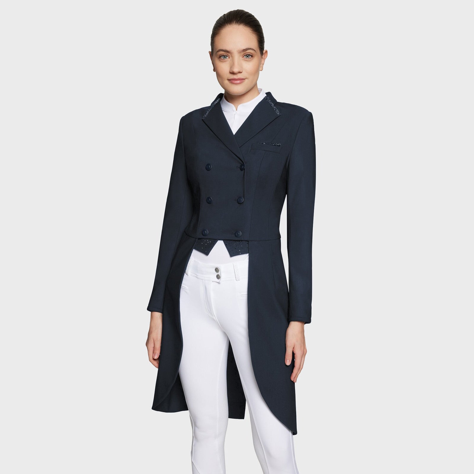 Full body front view of a female model wearing the navy Samshield Premium Frac and white breeches on a plain background