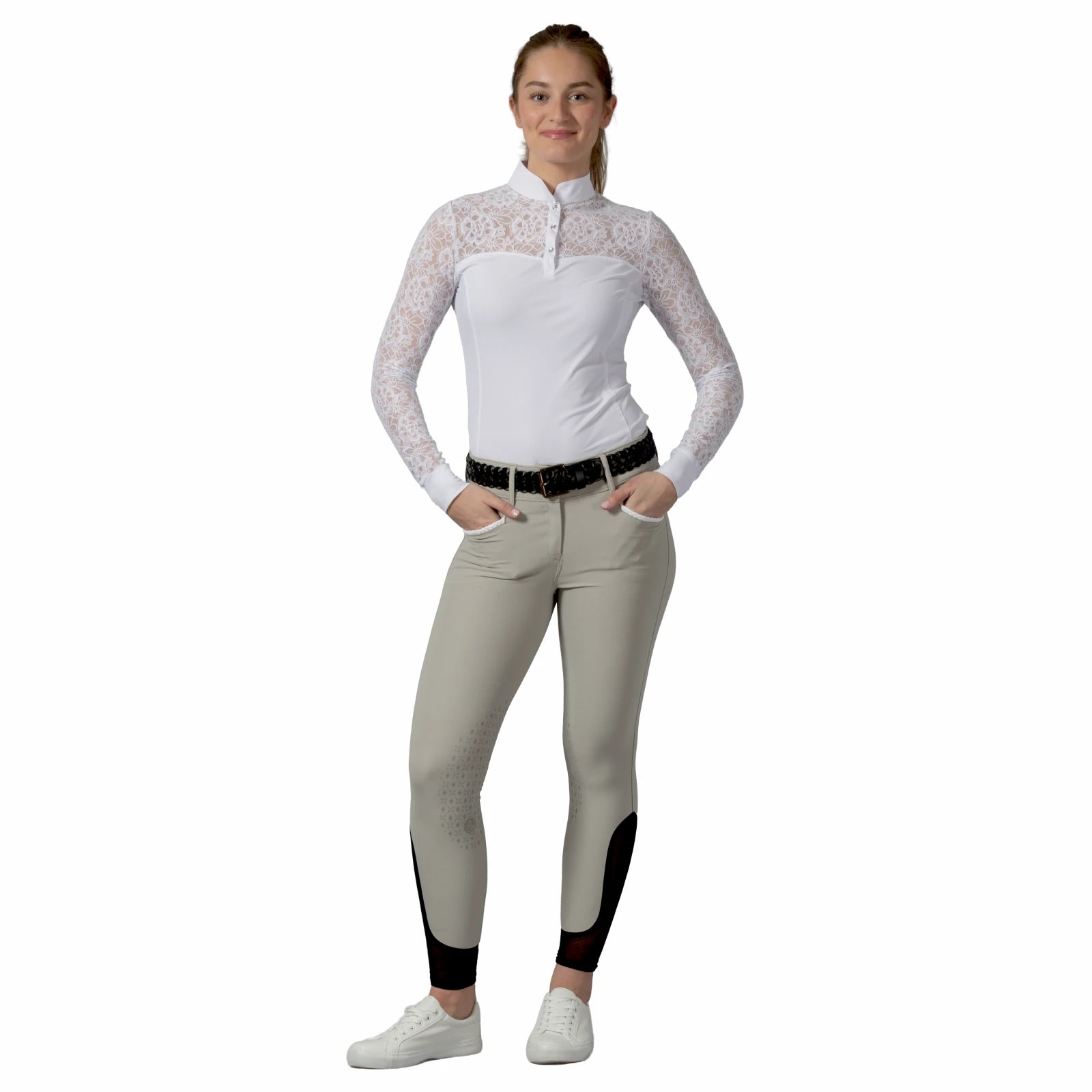 Full body front view of a female model wearing the white Equinavia Lisa Lace Long Sleeve Show Shirt with tan breeches on a white background