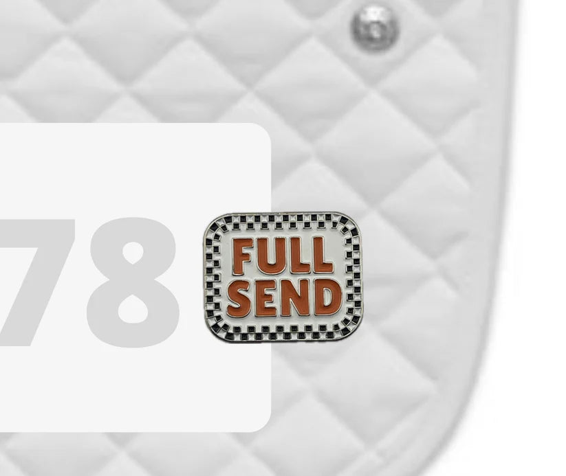 Side view of a white pad with numbers 378 and a Full Send Dubois Cheval Number Pin Charm on a white background