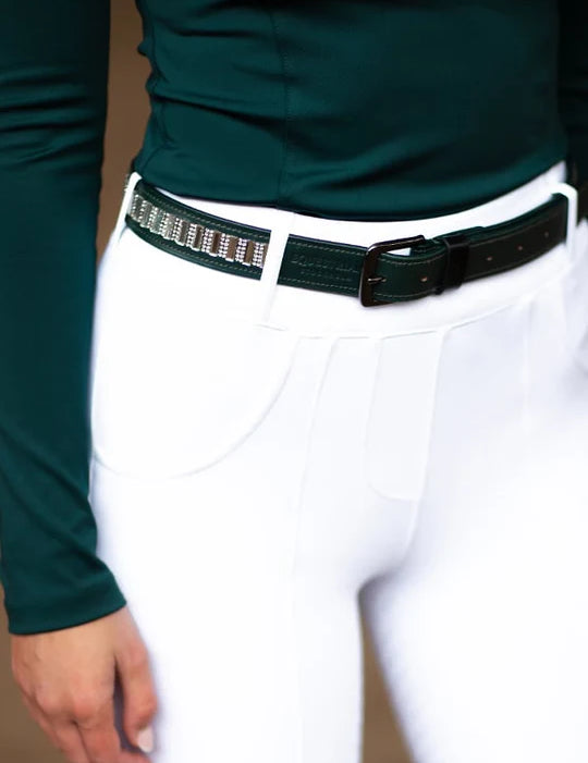 Close-up view of a model wearing the green Dramatic Monday Equestrian Stockholm Contest Belt with white breeches and coordinating green top