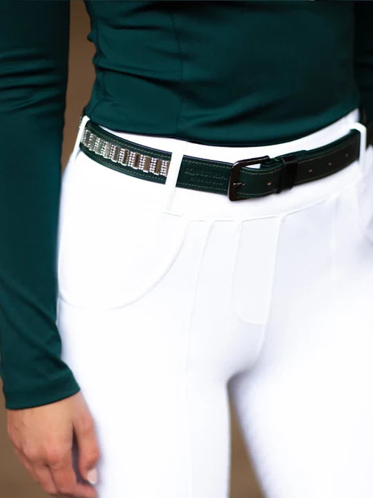 Close-up view of a model wearing the green Dramatic Monday Equestrian Stockholm Contest Belt with white breeches and coordinating green top