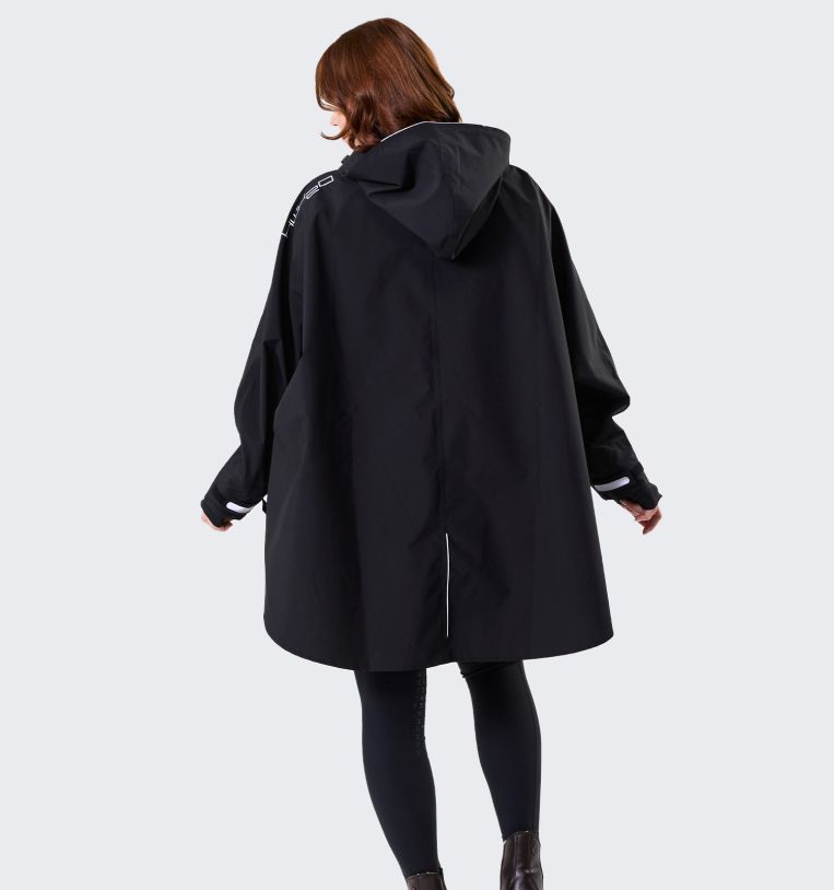 Model wearing Horseware H2O Poncho in black, back view