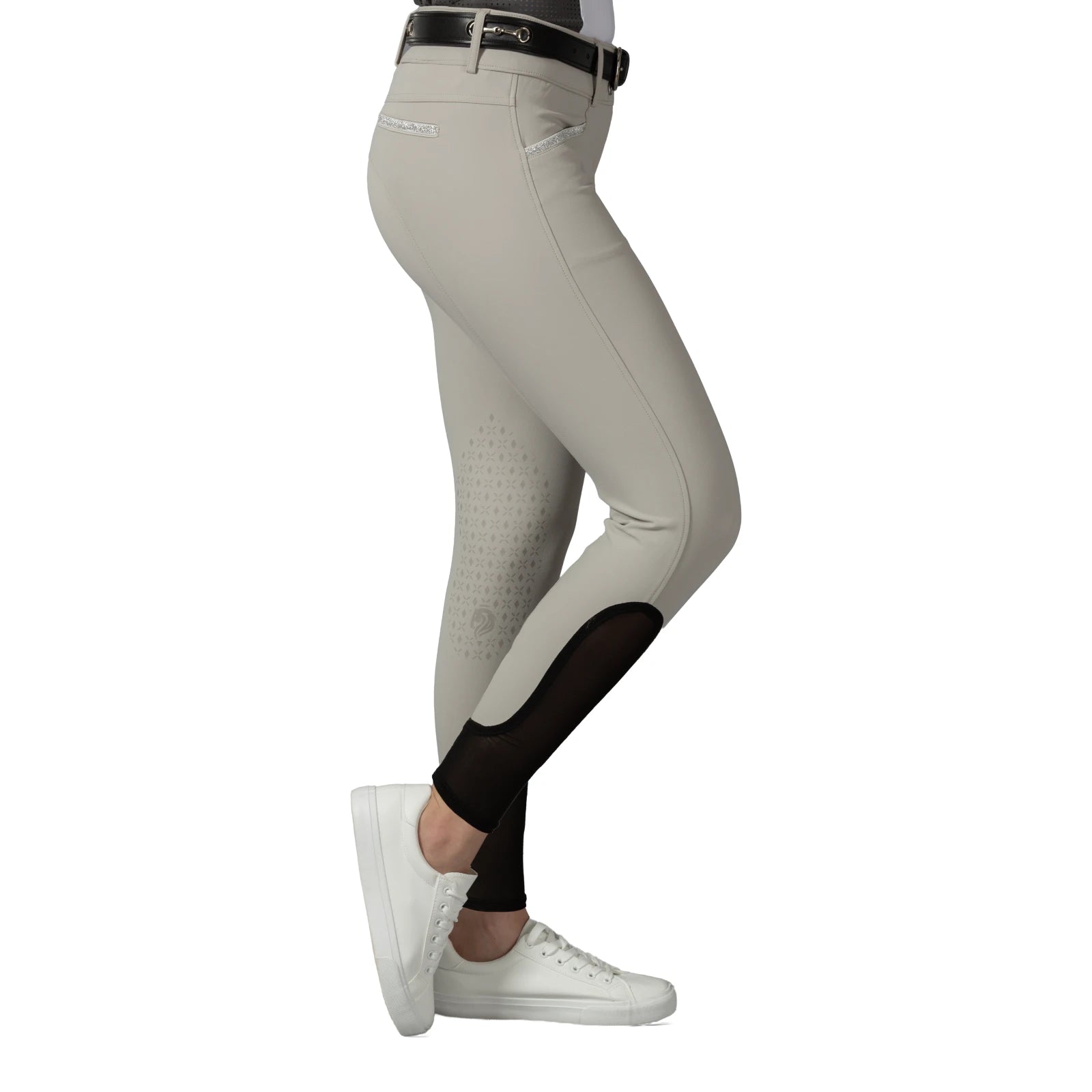 Side view of a model wearing the tan Equinavia Kristina Knee Patch Breeches on a white background