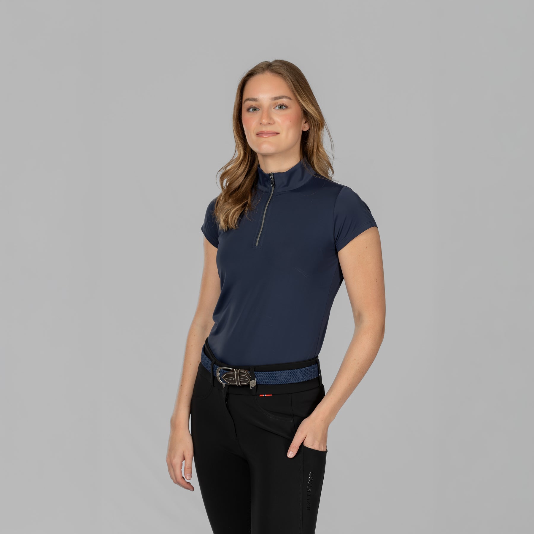 Angled frront view of a female model wearing the B Vertigo Aubrie Cooling Training Shirt on a plain background