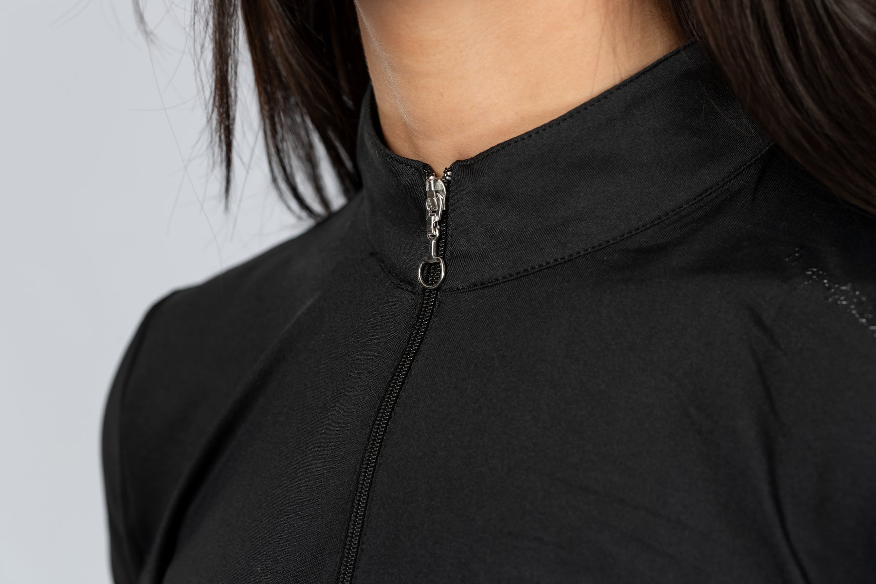 Close-up front view of a female model wearing the Black Horze Mina Mesh Short Sleeve Training Shirt on a plain background