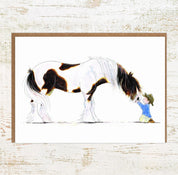 View of the Clydie Moment Pony Nut Greeting Card on a white washed wood background