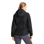Back view of a model wearing the navy Horze Fiora Lightweight Waterproof Jacket on a white background