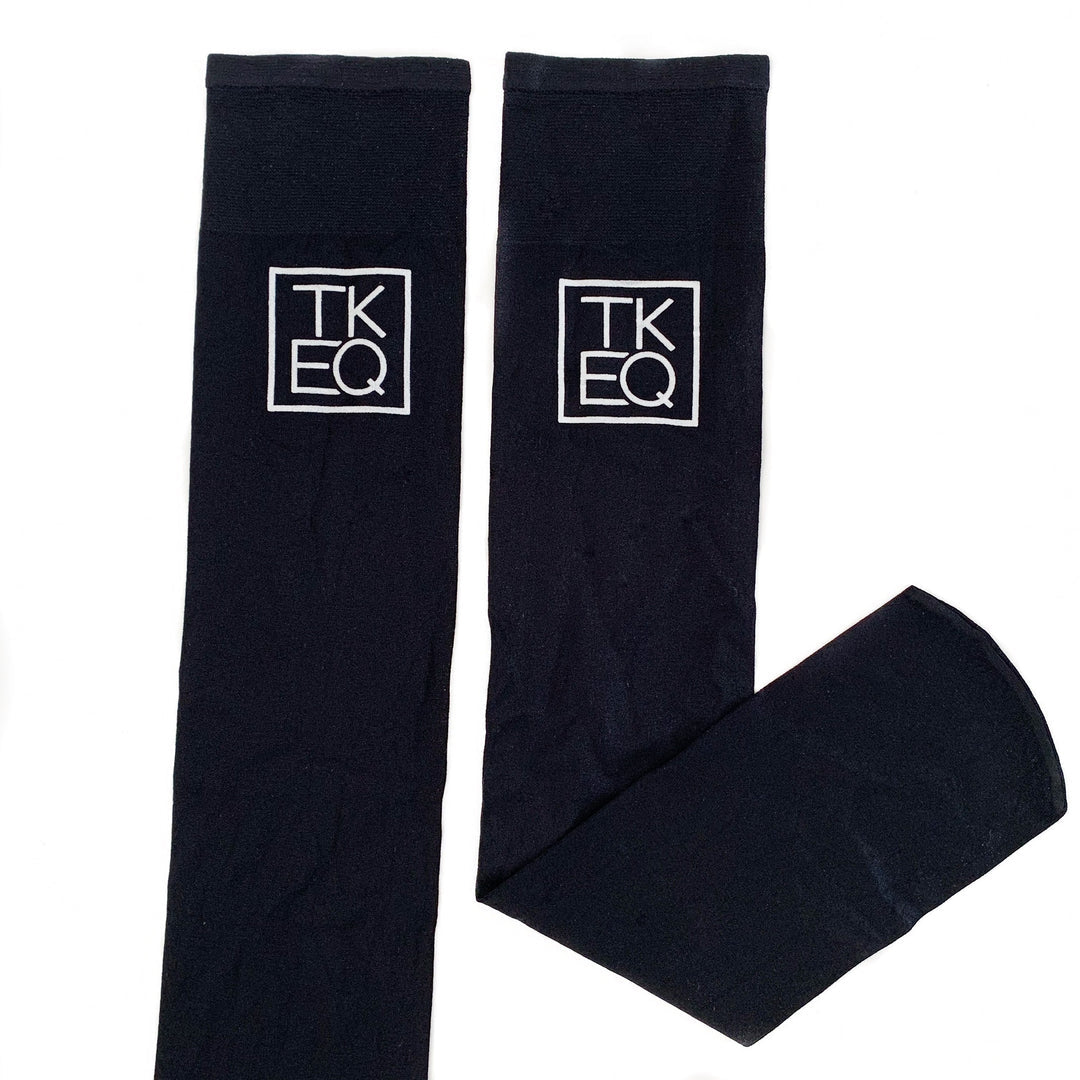 View of a pair of black TKEQ Logo Boot Socks on a white background