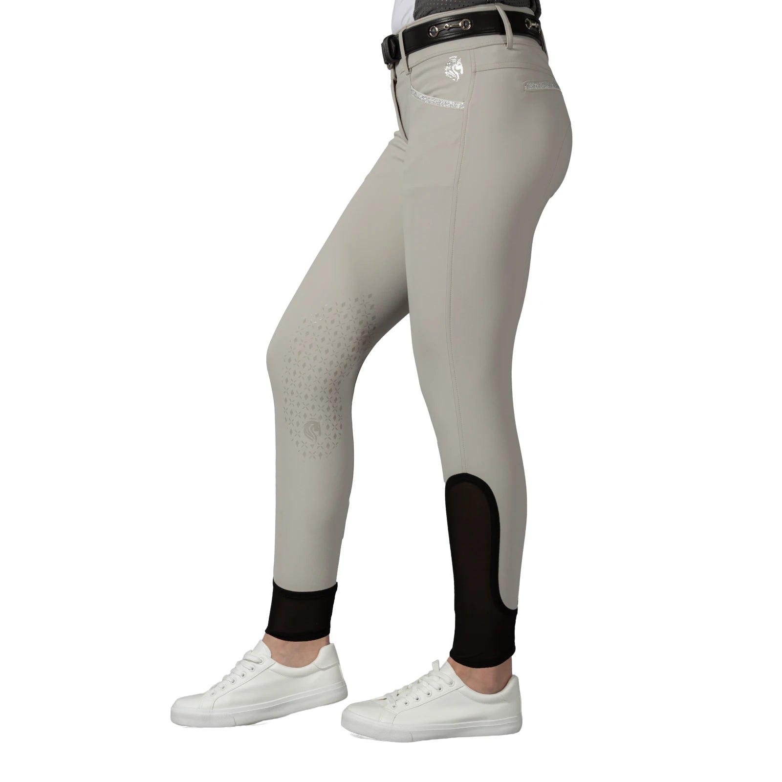 Side view of a model wearing the tan Equinavia Kristina Knee Patch Breeches on a white background
