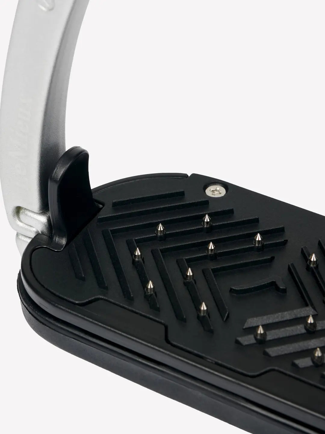 Close-up view of the tread on an aluminum LeMieux Vector Control Stirrup on a plain background