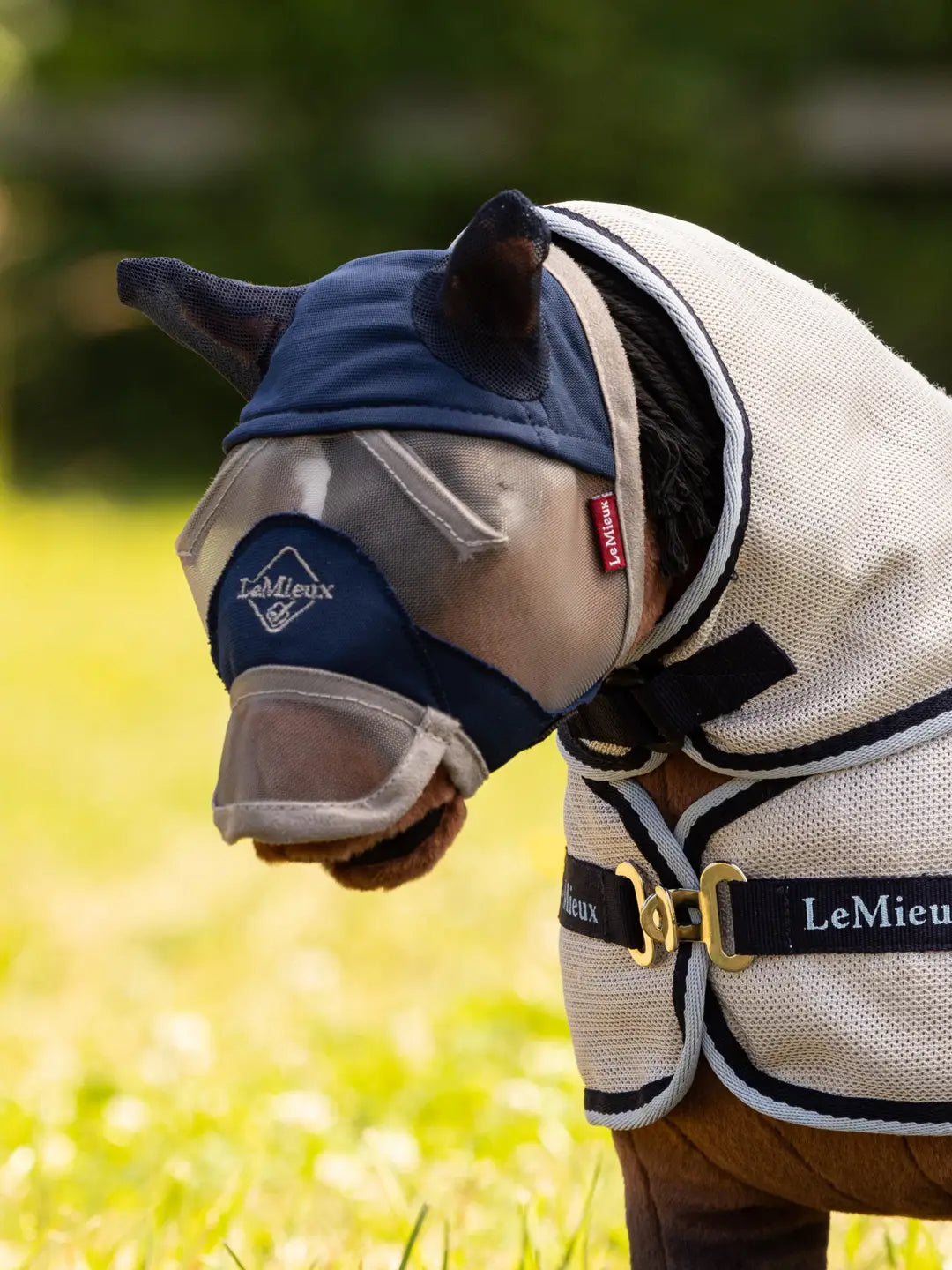 Toy Pony standing outside wearing the LeMieux Toy Pony Fly Mask in navy
